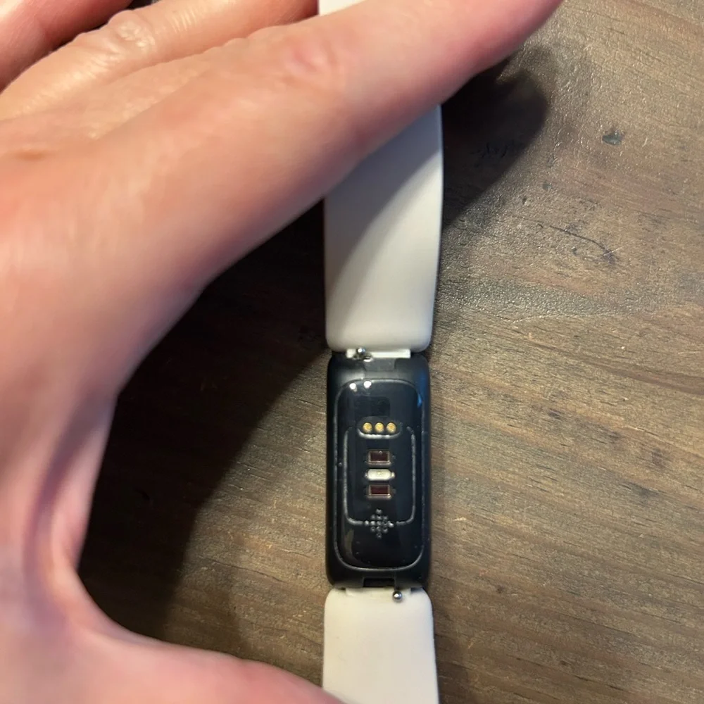 Black and White Fitness Tracker (FitBit with charger)